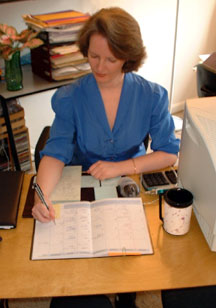 Busy woman fills out her calendar